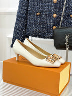 Louis Vuitton ladies’ light-colored flats with square toe and gold-tone LV buckle