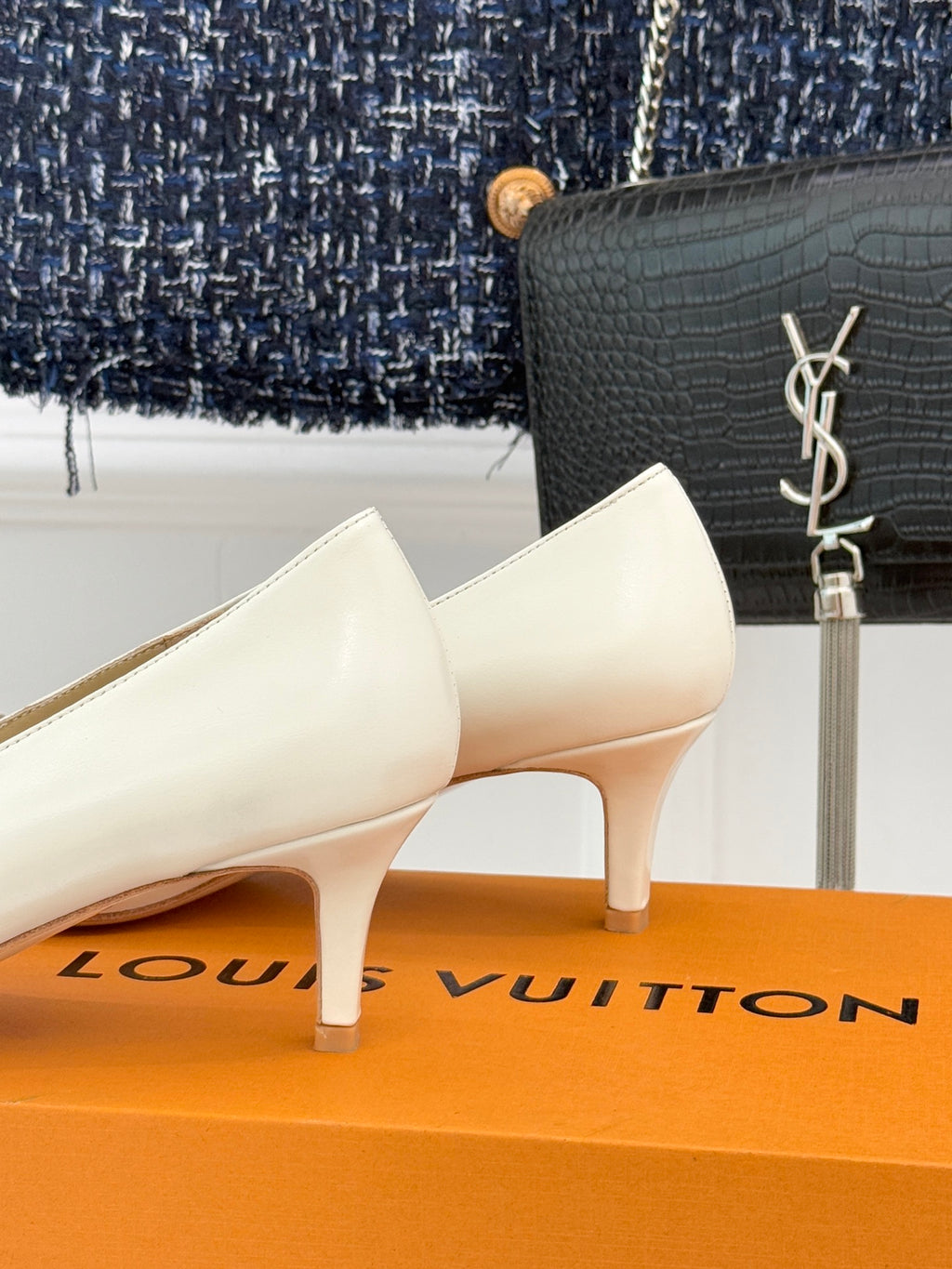 Louis Vuitton ladies’ light leather pumps with low heel and gold-tone LV buckle