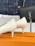 Louis Vuitton ladies’ light leather pumps with low heel and gold-tone LV buckle