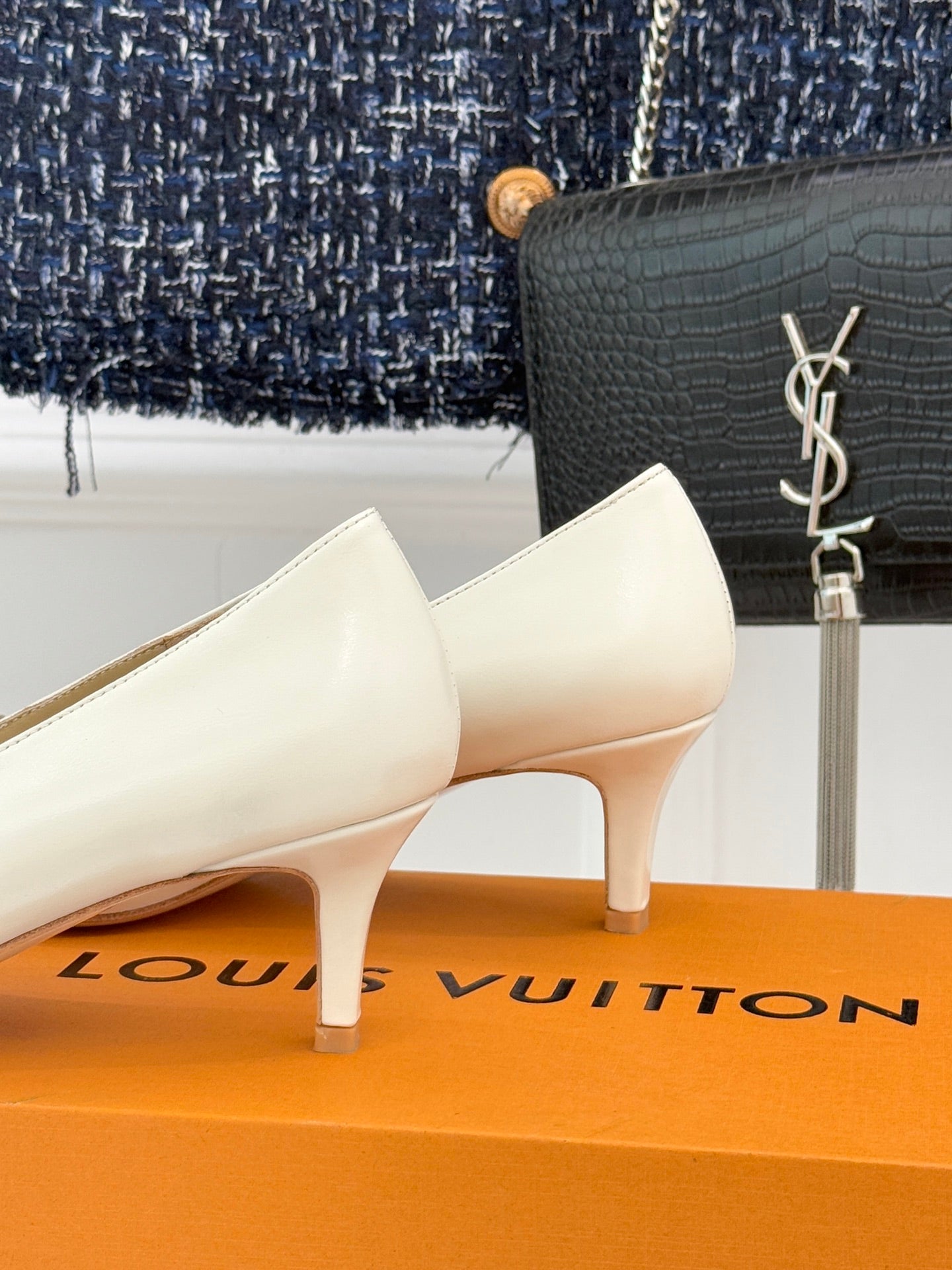 Louis Vuitton ladies’ light leather pumps with low heel and gold-tone LV buckle