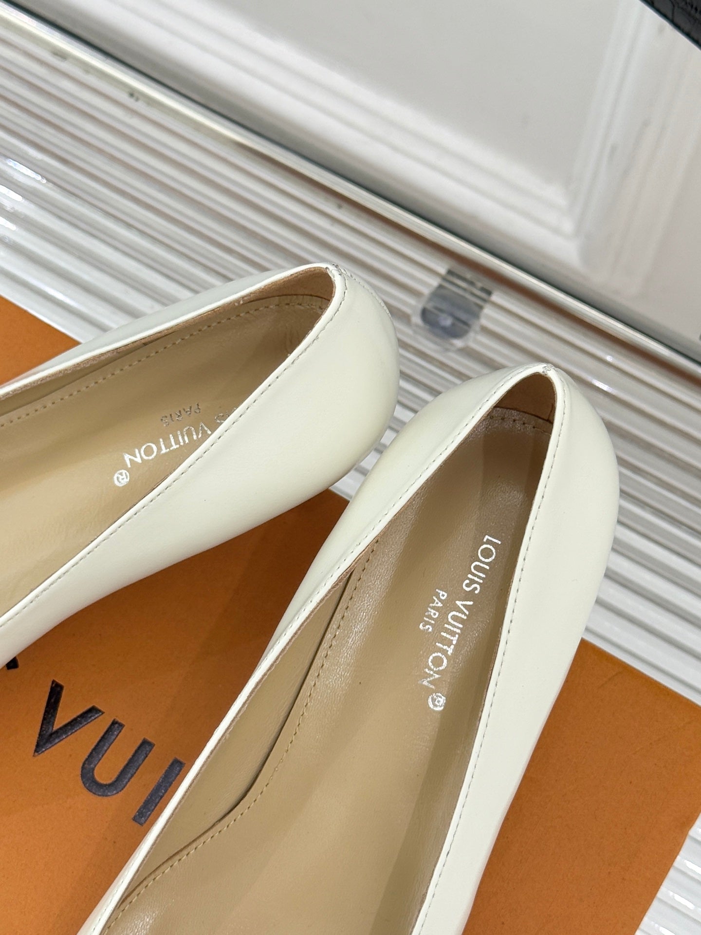 Louis Vuitton ladies’ light slip-on flats with square toe and gold-tone LV buckle
