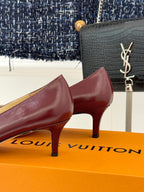 Burgundy leather low-heel pumps, side view; gold square logo buckle at toe.