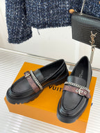 Black leather loafers with chain-trim strap and platform lug sole