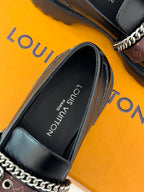 Black leather loafer with chain-trim strap and branded insole lining