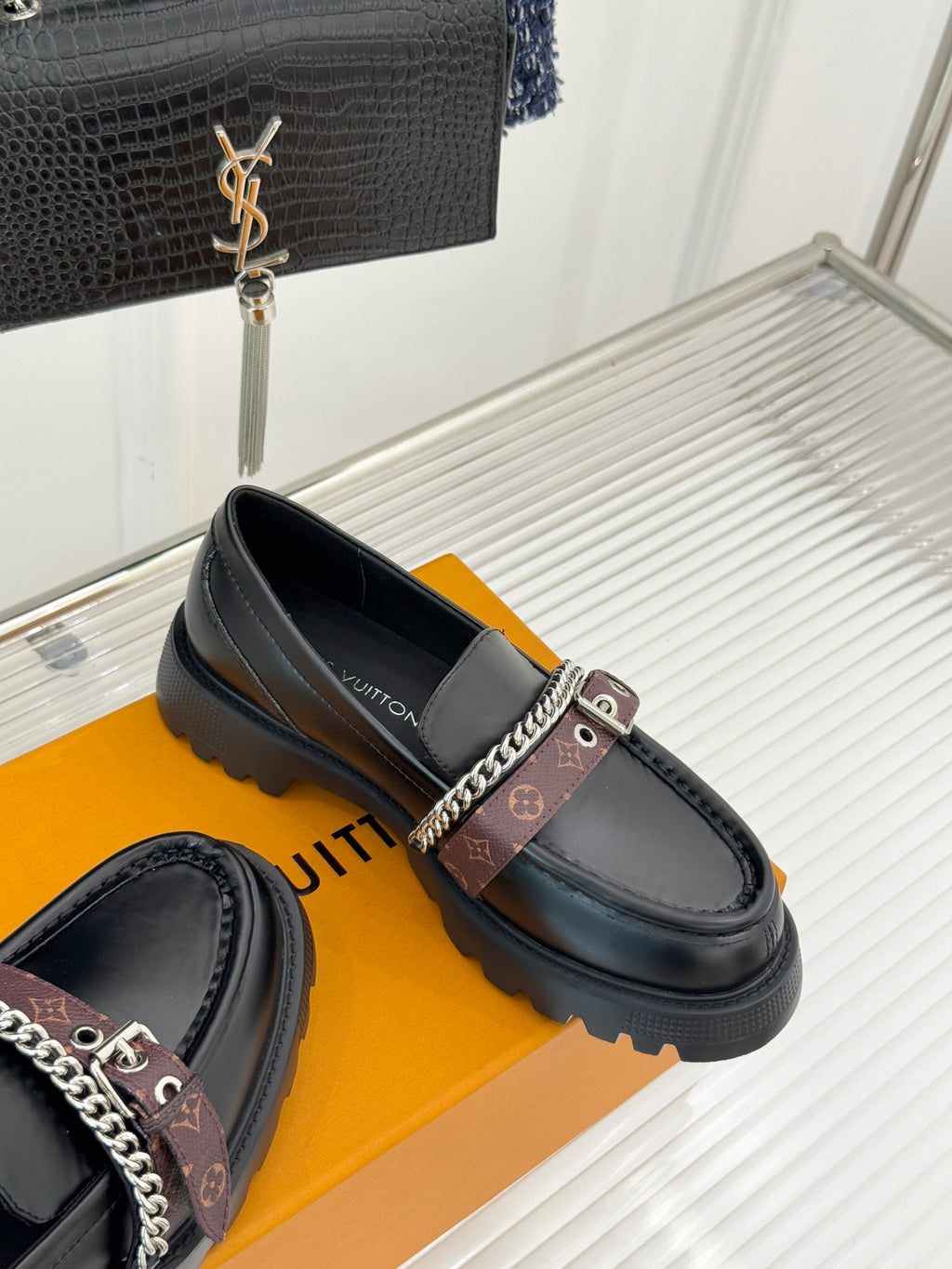 Black leather loafers with chain-trim strap and cushioned platform sole
