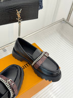 Black leather loafers with chain-trim strap and cushioned platform sole