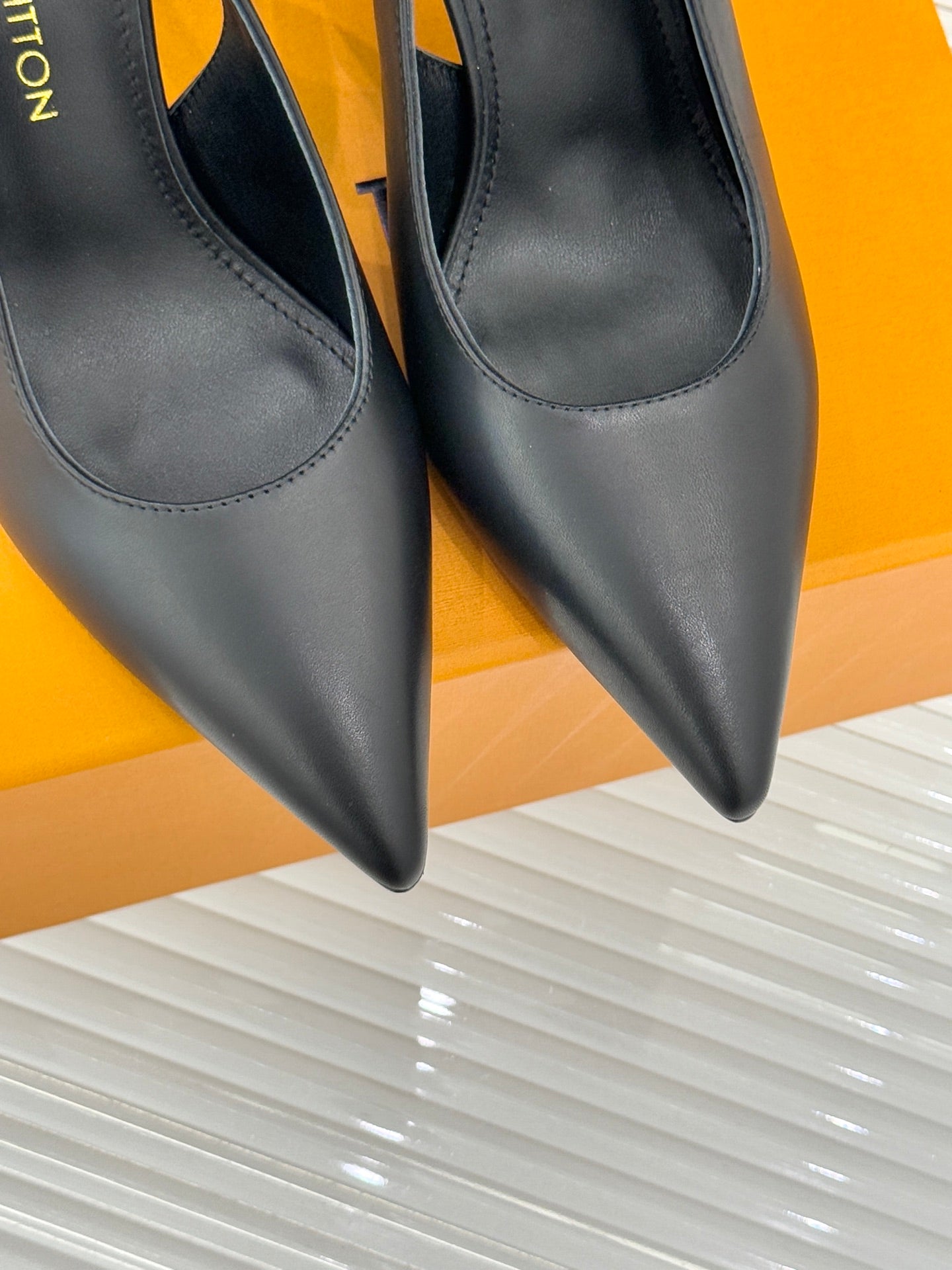 Louis Vuitton black pointed-toe heeled pumps, close-up of toe shape