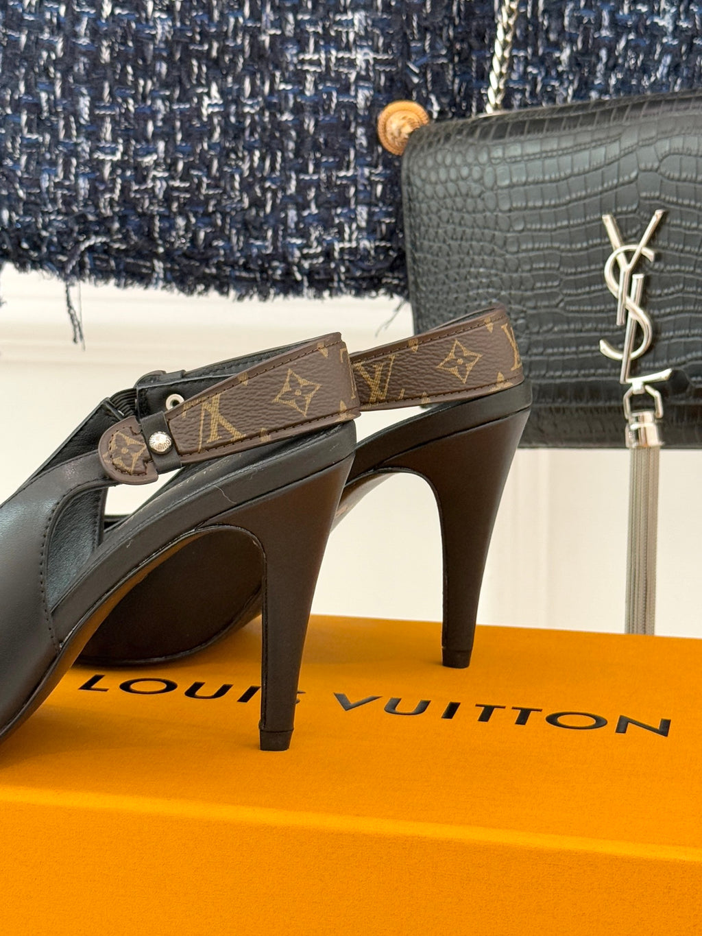 Louis Vuitton black pointed-toe heeled pumps on bright display box