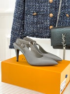 Light gray pointed-toe heeled slingback pumps with slim stiletto heel