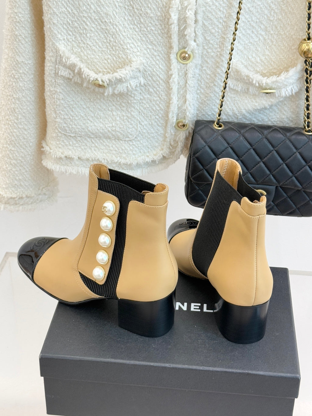 Chanel beige Chelsea boots with pearl side detailing, black elastic panels, glossy black toe
