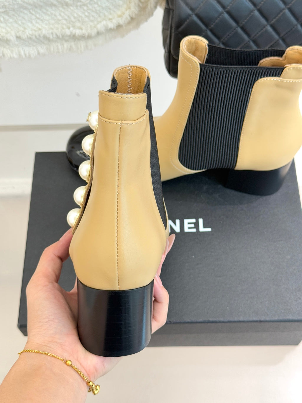 Chanel beige Chelsea boots with black elastic gore and pearl trim along the outer side
