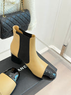Chanel beige Chelsea boots with black side elastic and glossy black toe caps, block heels