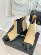 Chanel ankle boots in beige with black stretch gore and pearl trim, glossy black cap toe