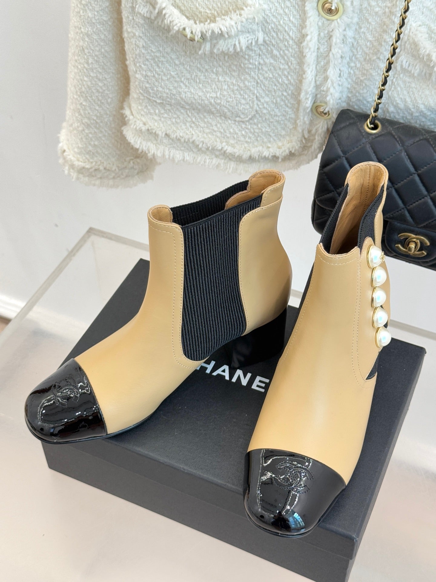Chanel ankle boots in beige with black stretch gore and pearl trim, glossy black cap toe