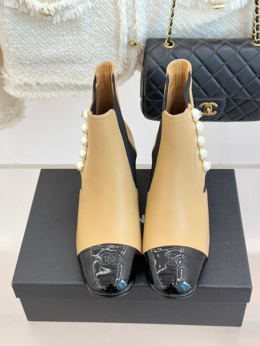 Pair of Chanel beige Chelsea boots with pearl side embellishment and black elastic gores