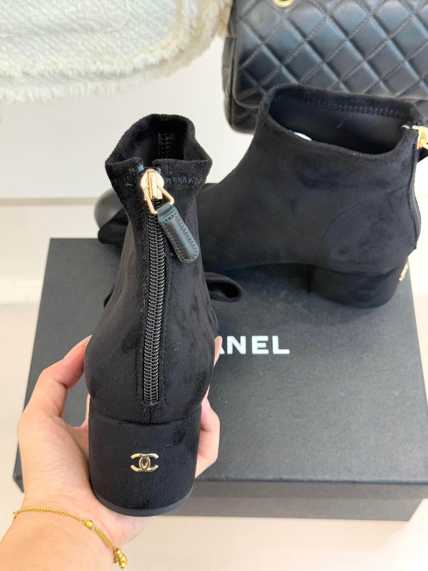 Chanel ladies ankle boots rear view with zipper and pull tab, block heel, dark suede.