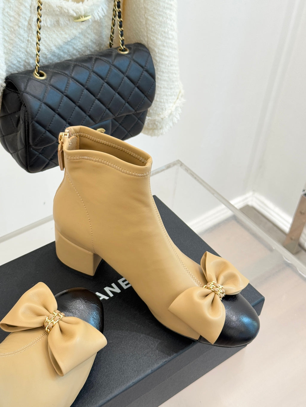 Beige ankle boots with block heel and ribbon bow on front, side zipper