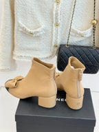 Beige ankle boots with bow on front and side zipper, low block heel