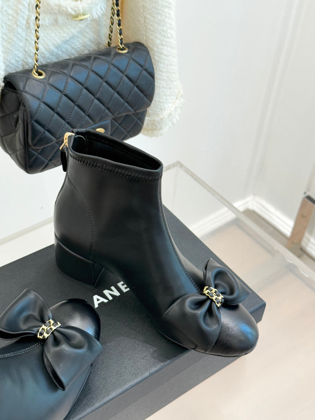 Chanel dark navy leather ankle boots with bow detail and block heel view
