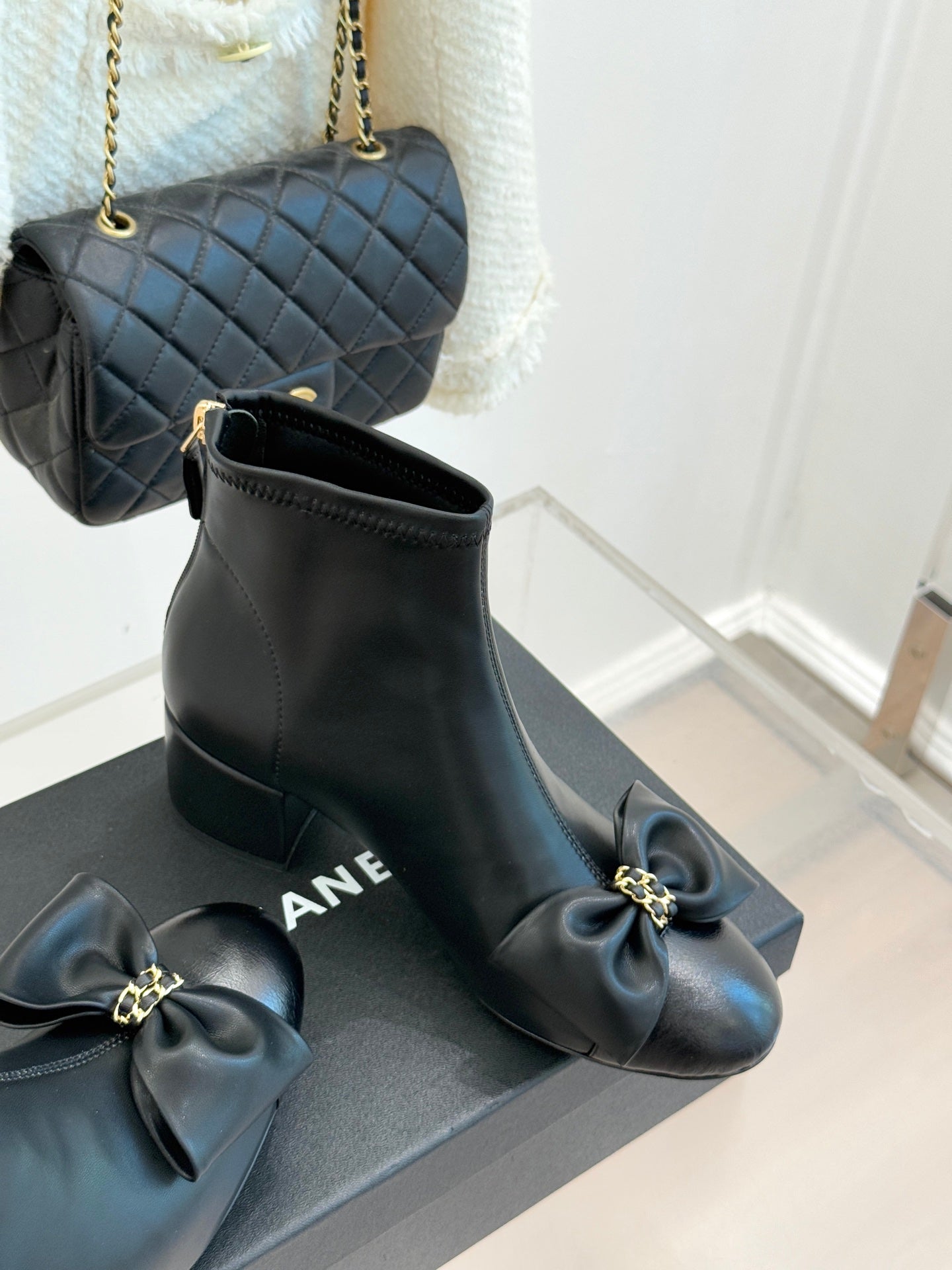Chanel dark navy leather ankle boots with bow detail and block heel view