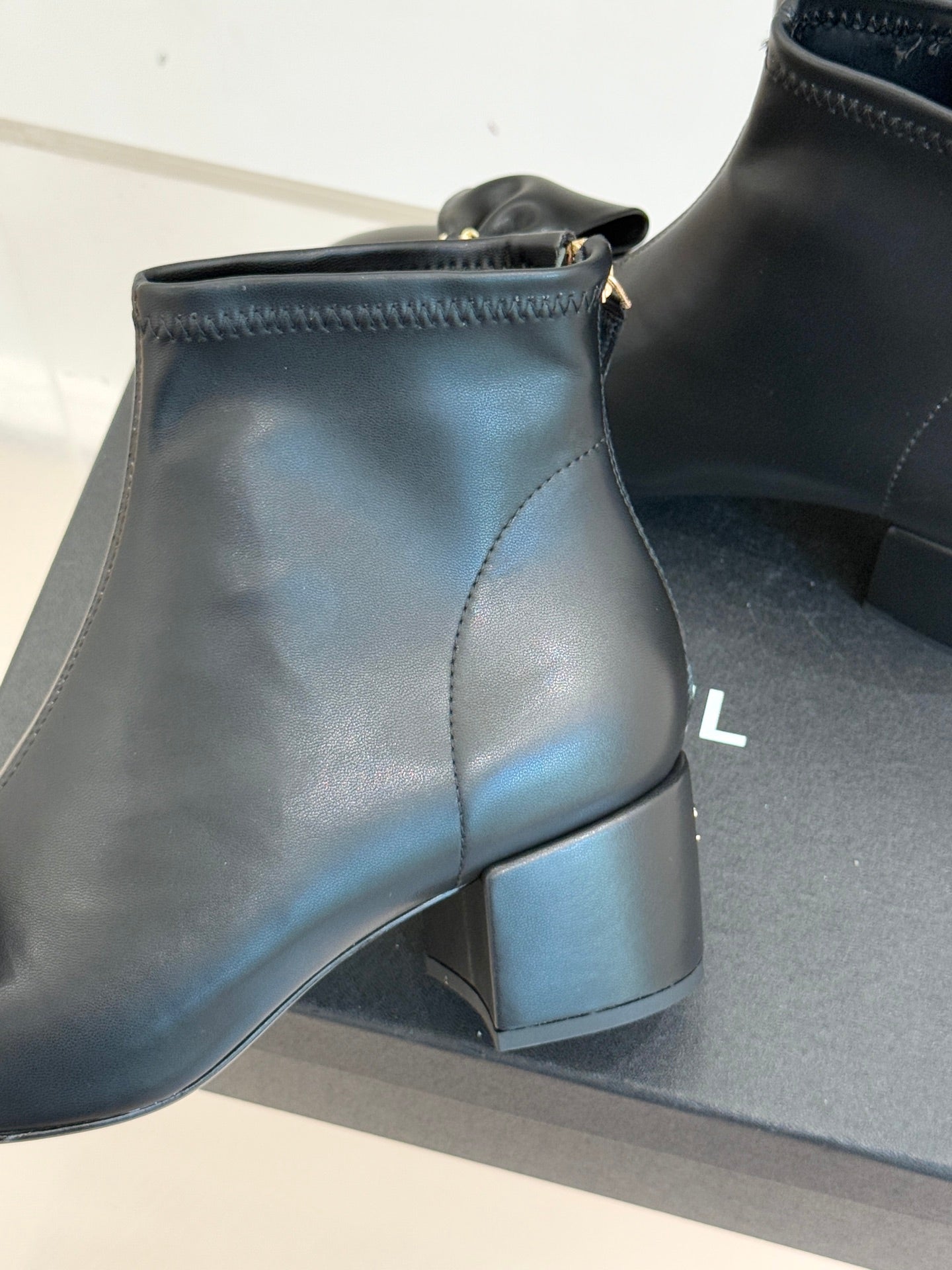 Chanel dark navy leather ankle boot with block heel and gold-tone zipper pull