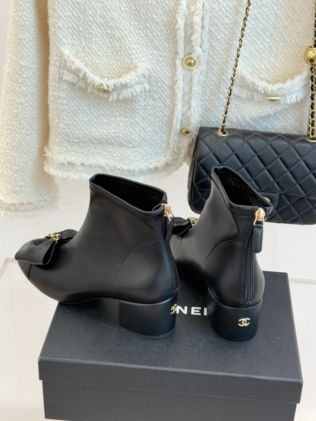 Chanel dark navy leather ankle boots with bow detail and side zipper, on box
