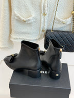 Chanel dark navy leather ankle boots with bow detail and side zipper, on box