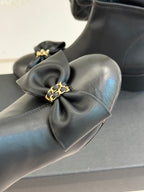 Chanel dark navy leather ankle boot with large bow detail on toe, close-up