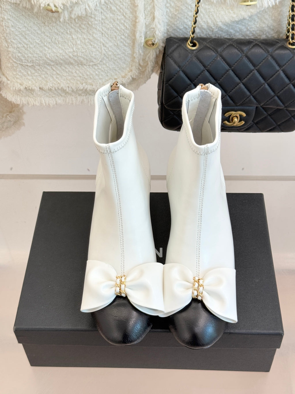 White ankle boots with bow straps and block heel, side zipper closure