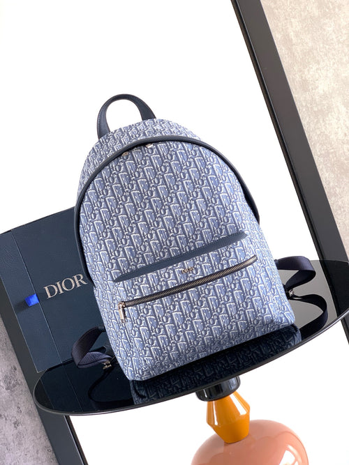 Dior men’s backpack in light blue with repeating Dior pattern and zip top