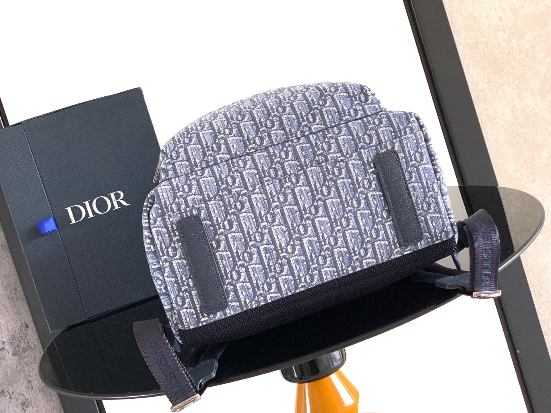 Dior men’s backpack with light blue monogram pattern front and side strap accents