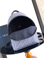 Dior mini backpack interior shown open with fabric lining and top zipper