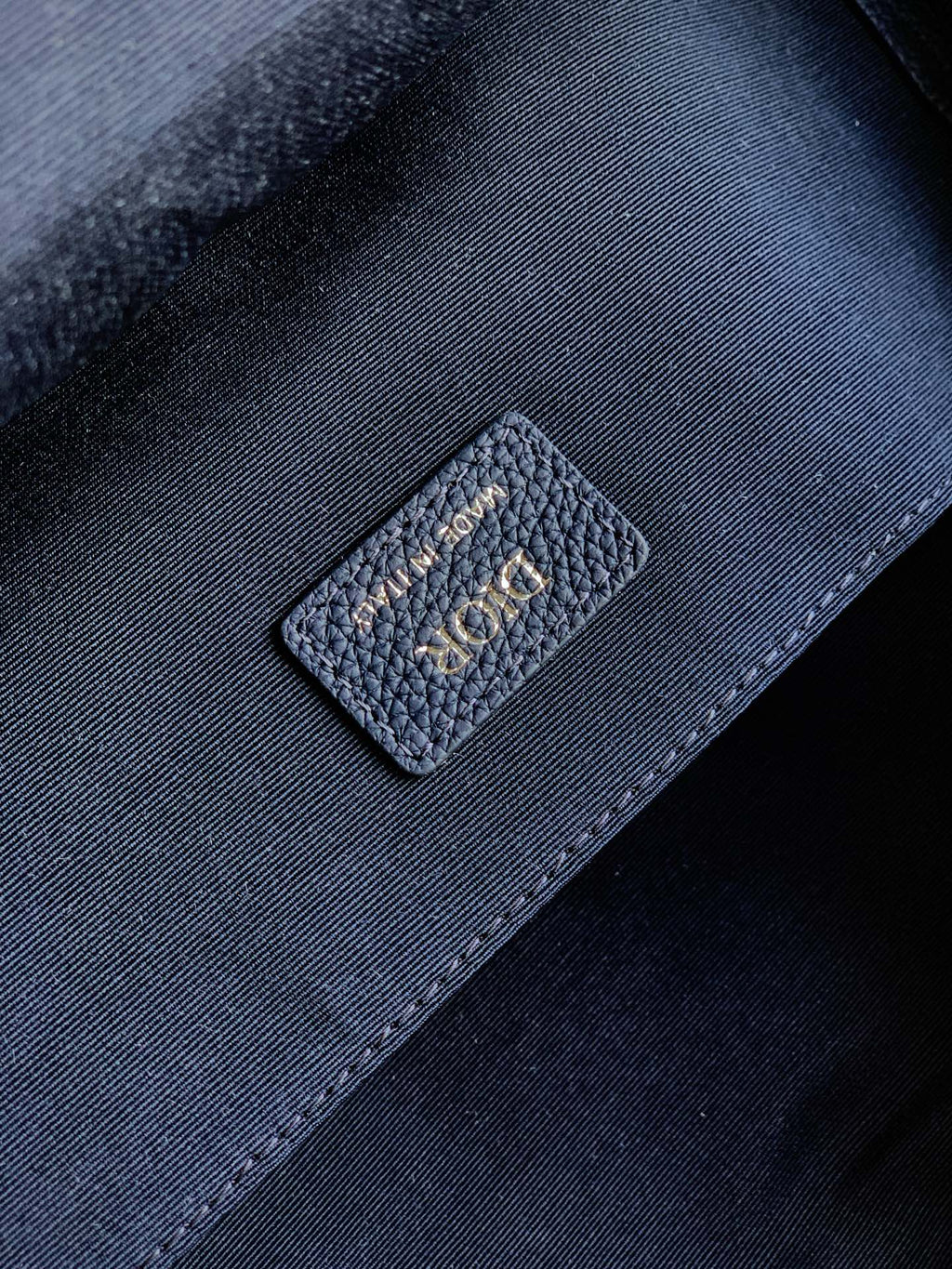 Dior mini backpack interior fabric patch with small “Dior” logo label