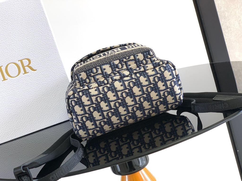 Men’s Dior mini backpack front view in blue/cream monogram with black shoulder strap