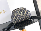 Men’s Dior mini backpack front view in blue/cream monogram with black shoulder strap