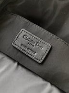 Dior bag internal label reading Christian Dior, Made in Italy on black fabric