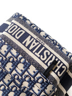Dior backpack detail: blue and beige jacquard with bold white logo band