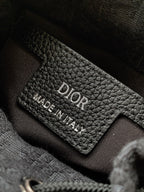 Dior leather label reading 'DIOR' and 'MADE IN ITALY' inside black bag