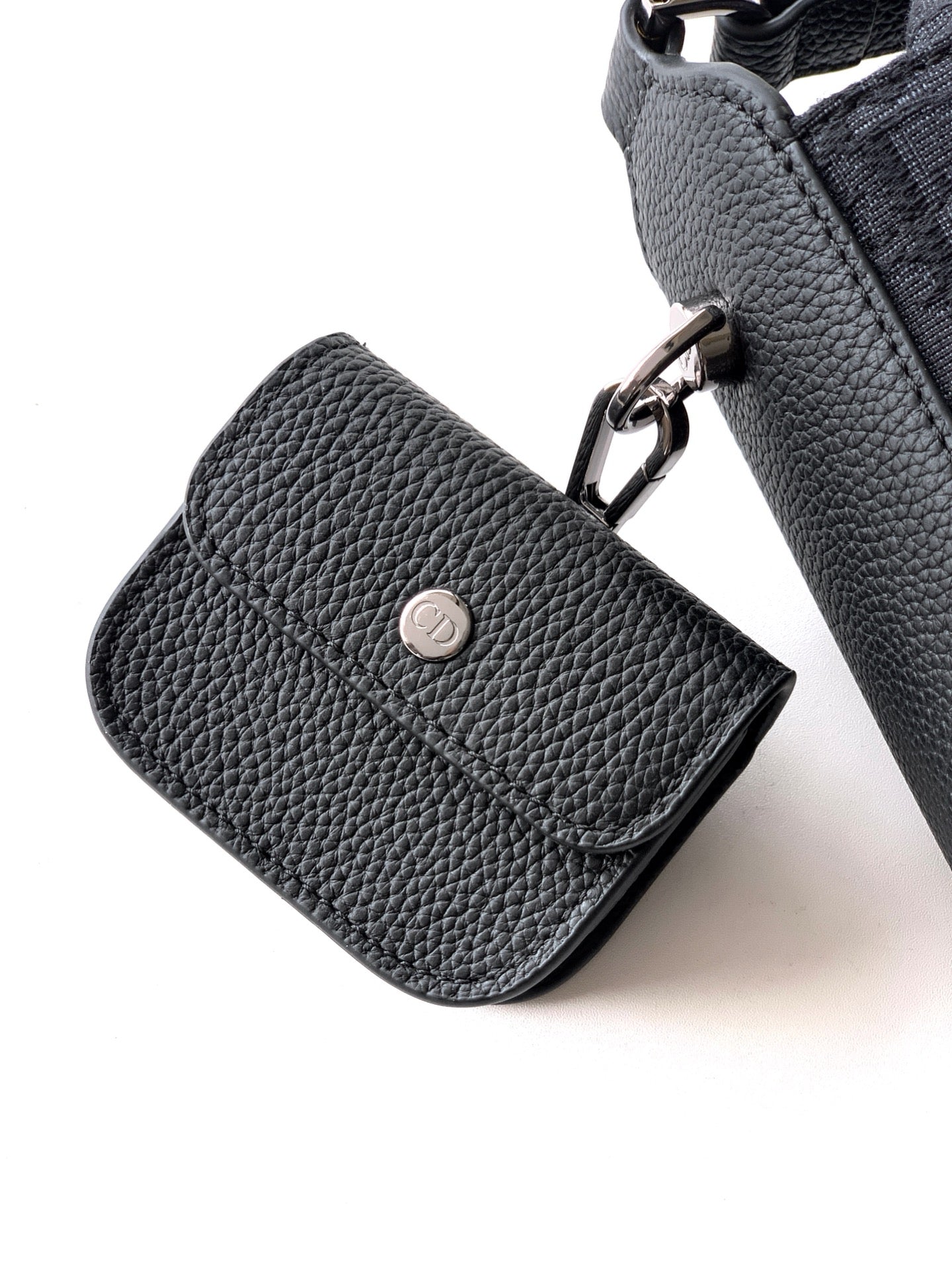 Small Dior leather bag, pebble-grain texture with round metal logo button