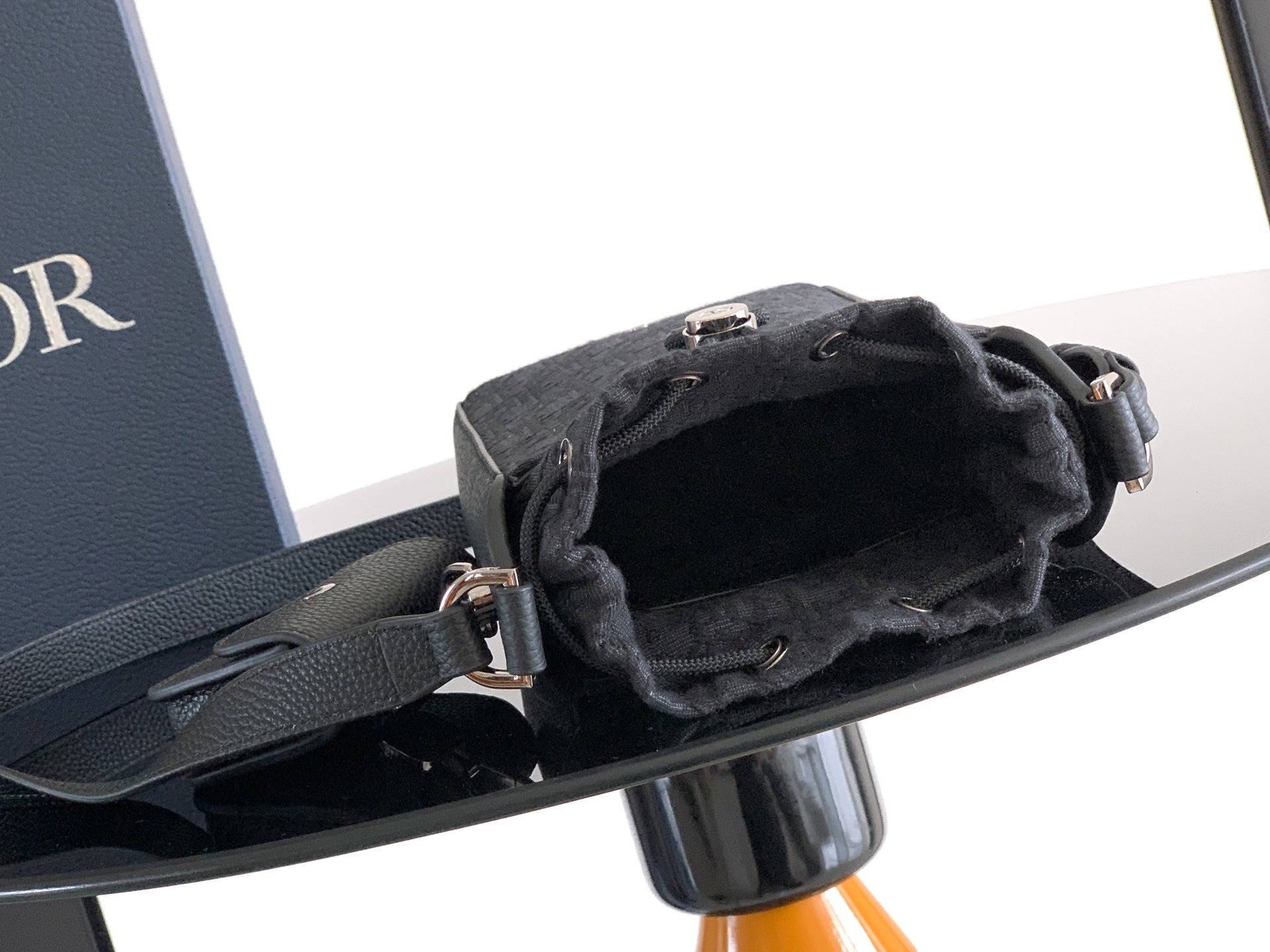 Dior open mini bag with drawstring top, adjustable shoulder strap and metal rings
