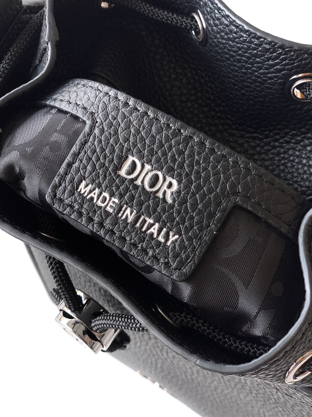 Black leather bag interior with Dior label reading Made in Italy