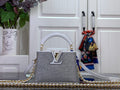 Louis Vuitton handbag in white, textured finish, gold LV logo, chain strap