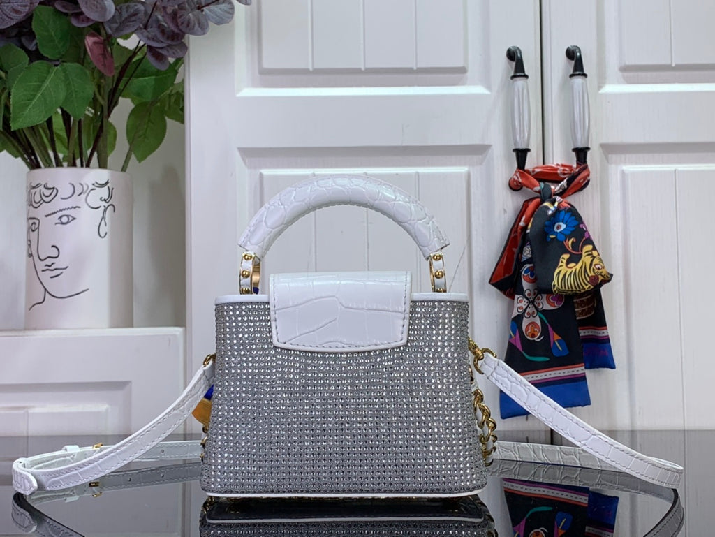 Handbag with white top handle and flap front, gold hardware