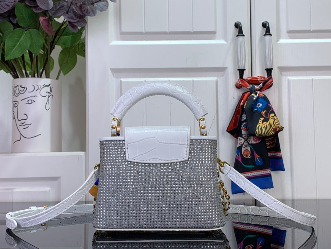 Handbag with white top handle and flap front, gold hardware