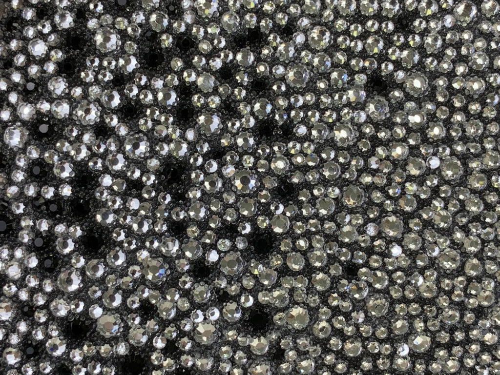 Silver rhinestone-studded exterior texture on a black mini bag