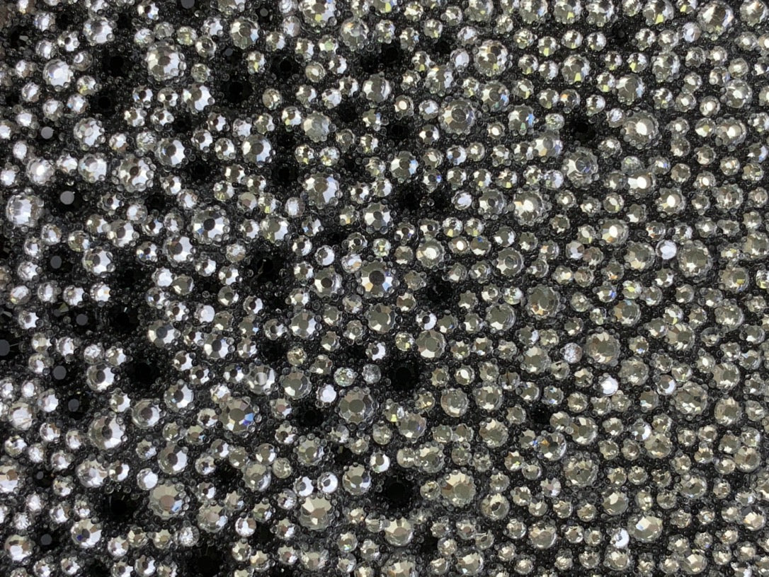 Silver rhinestone-studded exterior texture on a black mini bag