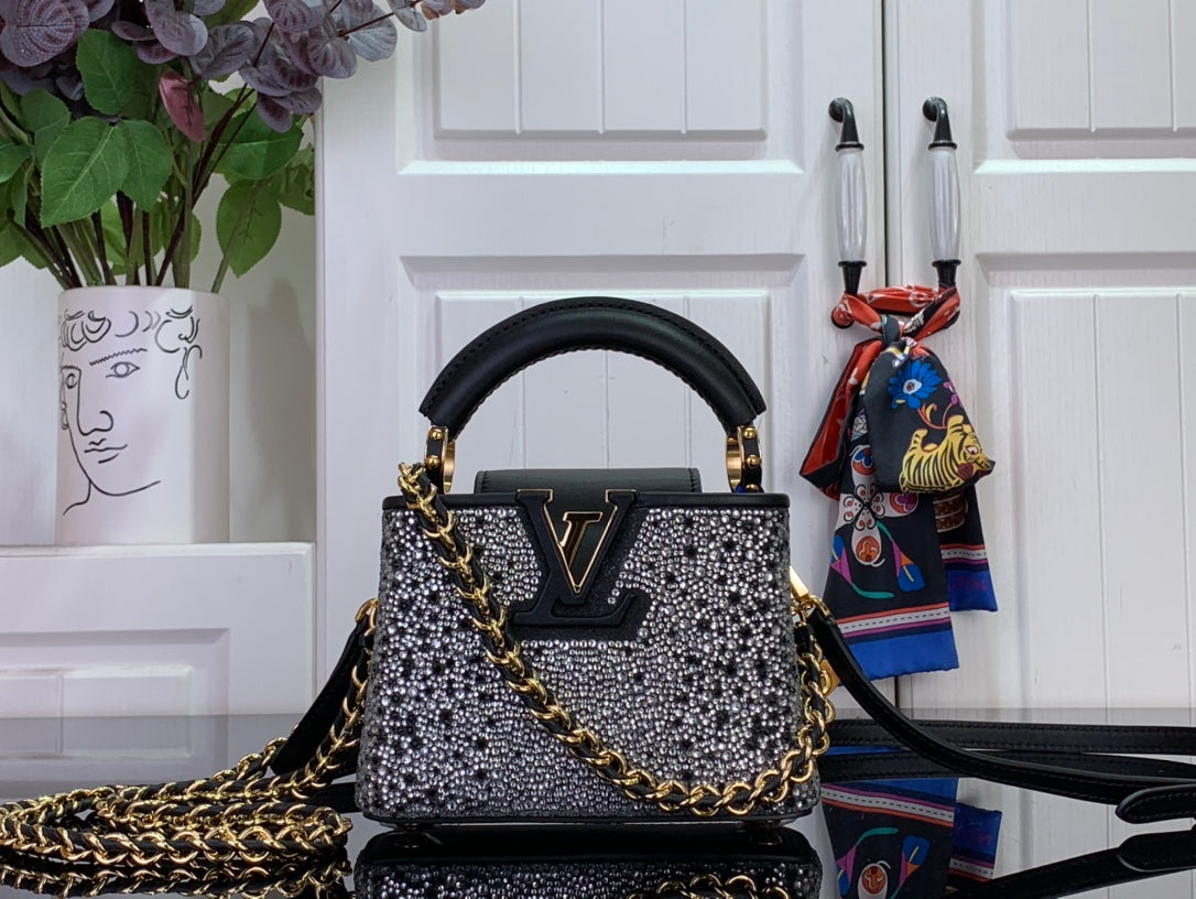 Louis Vuitton mini bag in black with silver studded pattern and gold chain strap