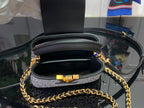 Black mini bag interior with leather lining and gold clasp hardware