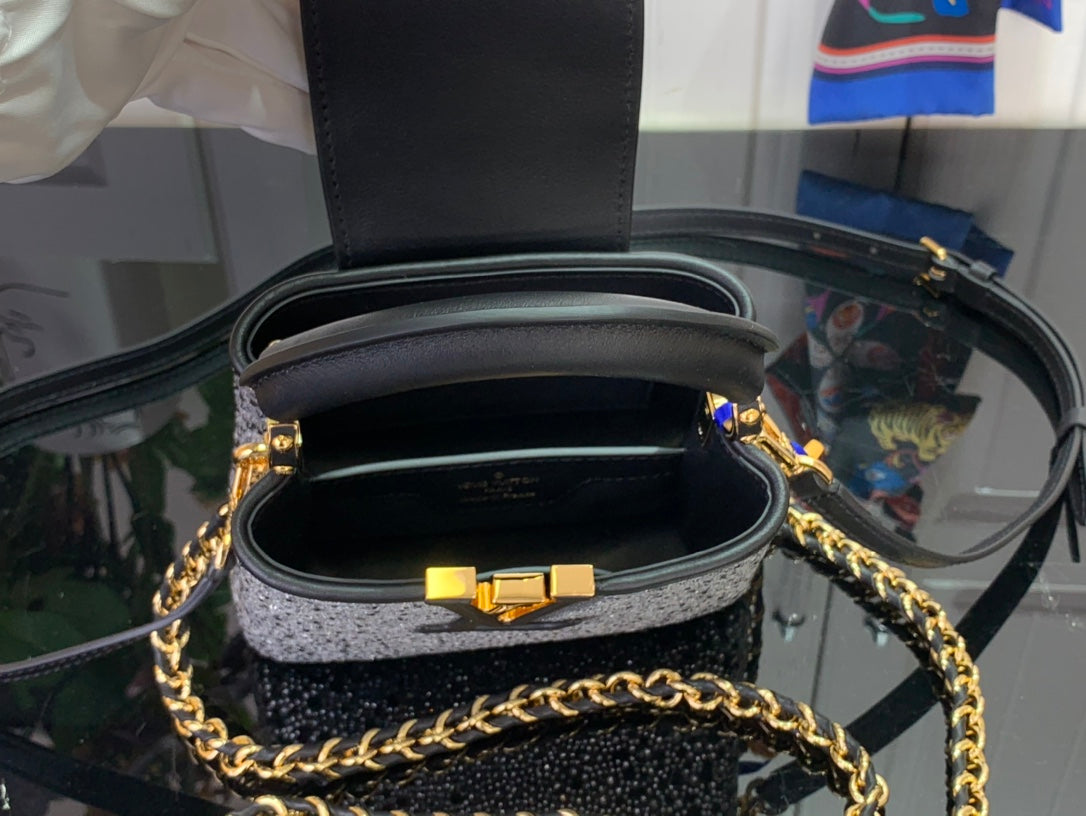 Black mini bag interior with leather lining and gold clasp hardware