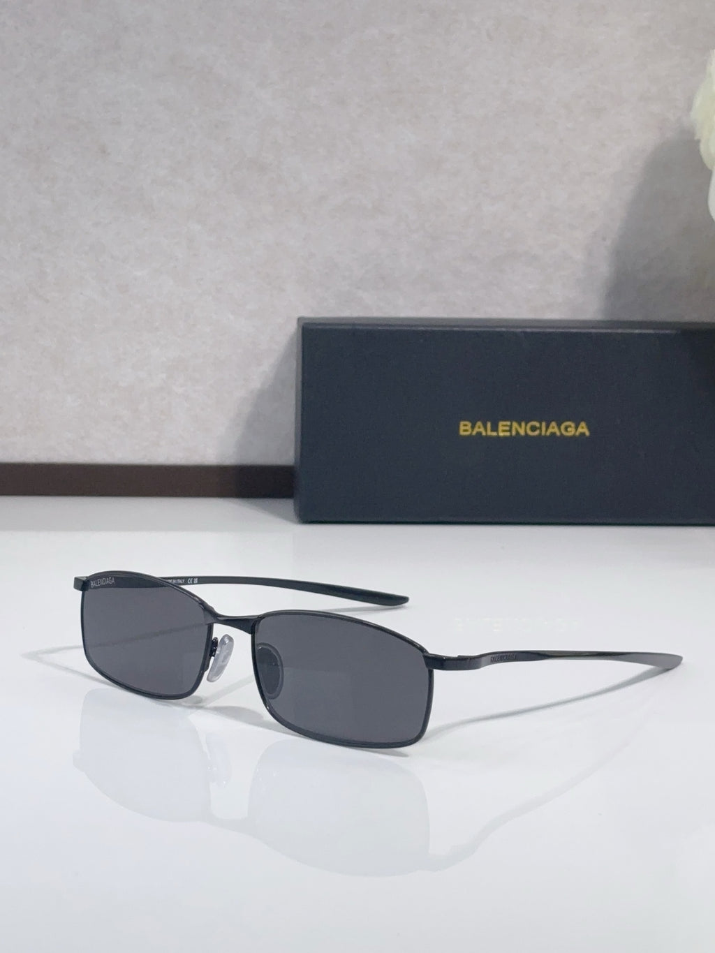 Balenciaga sunglasses with dark frame and gray rectangular lenses
